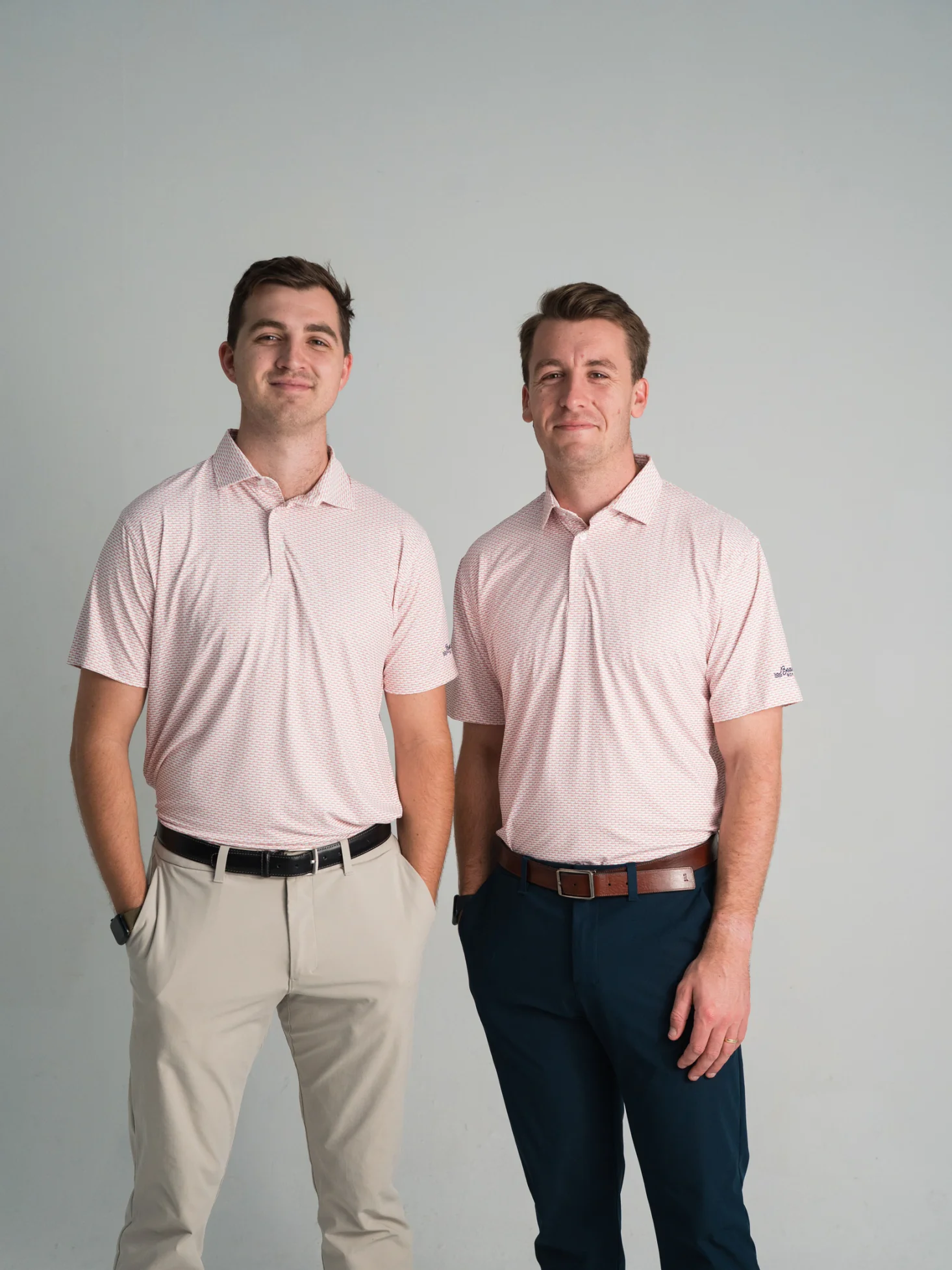 Two men wearing matching pink Beach Box micro print polos