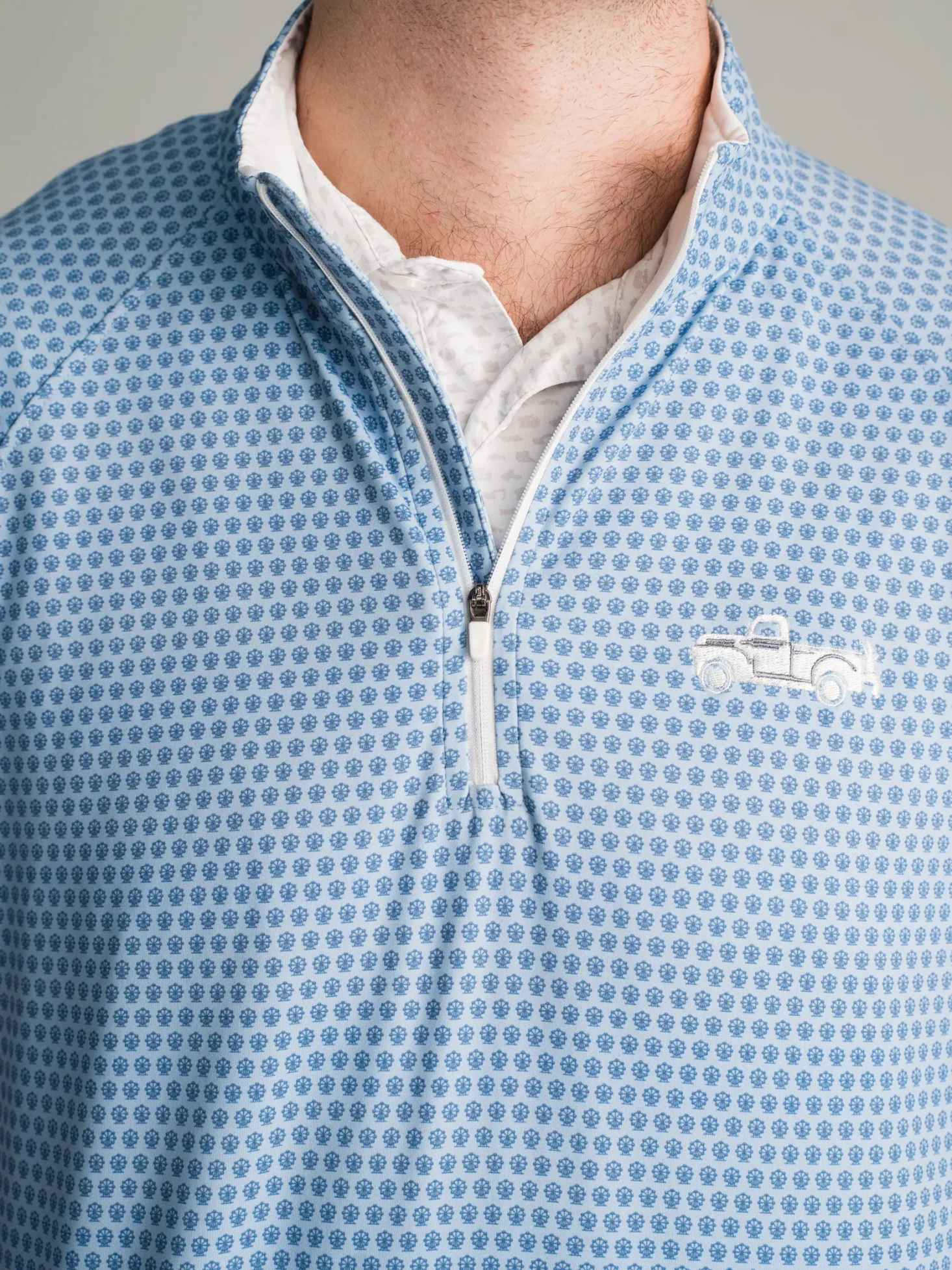 Light blue custom quarter zip with a geometric pattern and truck embroidery
