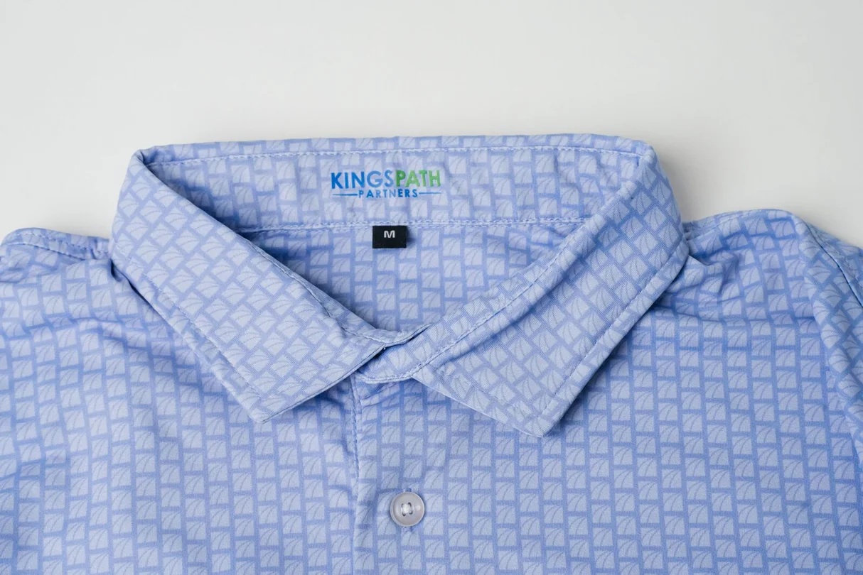 Kings Path Partners polo with a blue tonal logo micro print