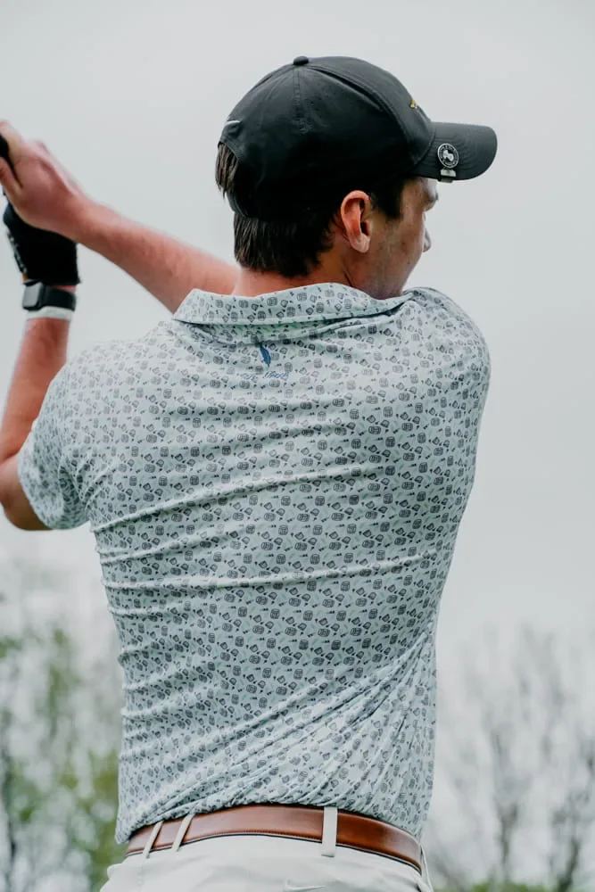 Custom golf polo moving through a full swing on the course