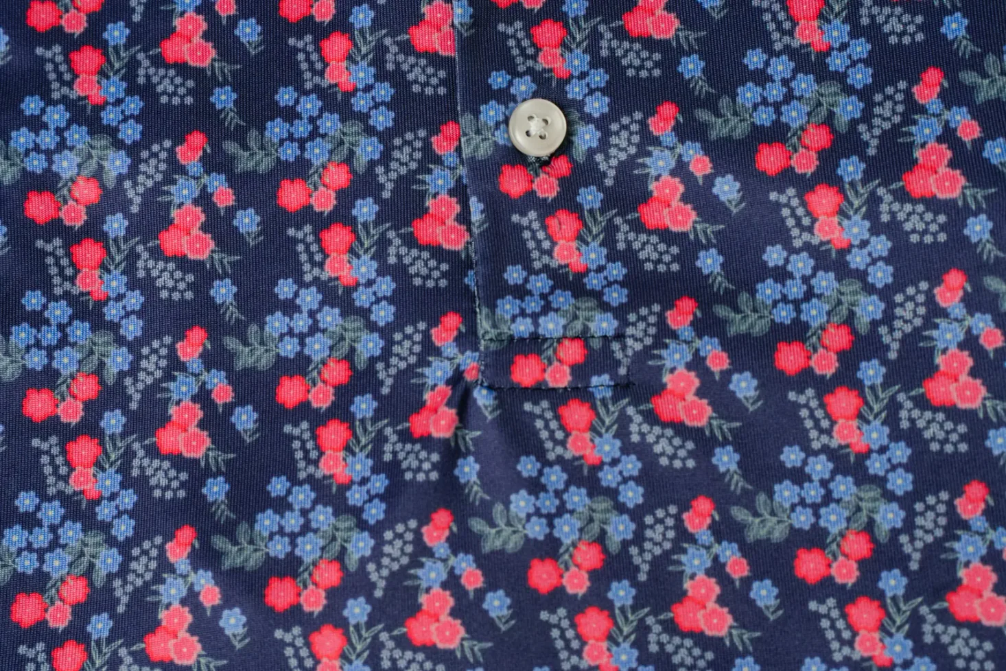 Custom golf shirt with a red and blue floral micro print