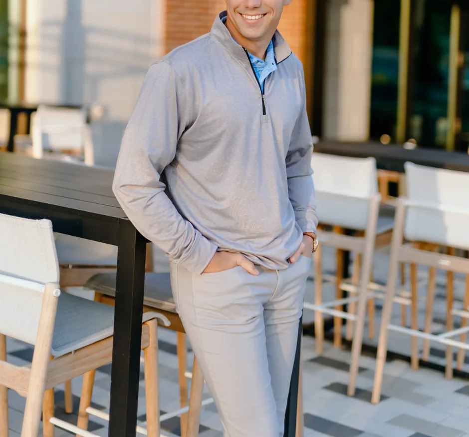 Custom quarter zip shown from across the room with a subtle branded pattern